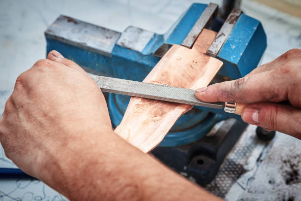 istock Grinding the copper billet with a file 1044166028