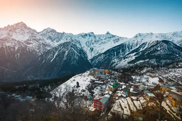 Beautiful landscape of little village in between snow-caped mountains of Kinner Kailash in Himalayas. Shoot location Kalpa, kinnaur district of Himachal Pradesh, India.