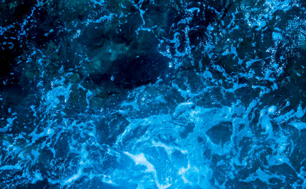 istock Blue deep sea foaming water background 1044171592