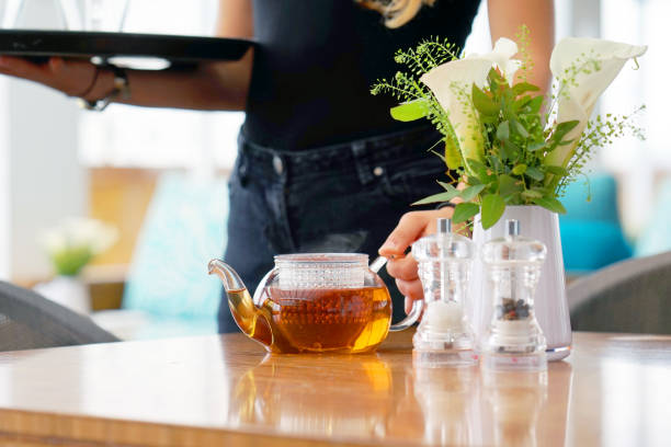 istock The waitress gives tea to the client 1044174816