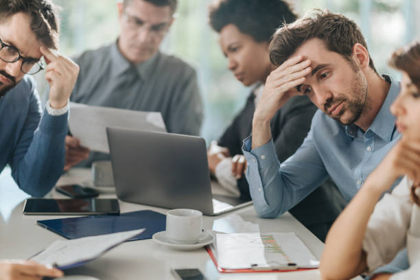 istock Worried business people working on reports in the office. 1044177394