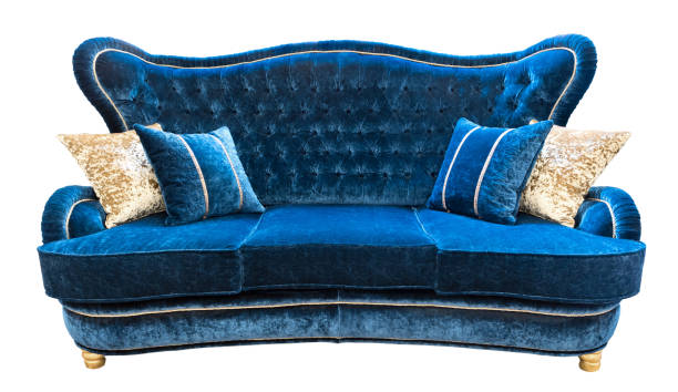 istock Blue velours sofa with pillows. Soft luxury classical couch with cushions isolated background. 1044177492