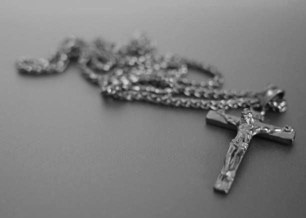 istock crucifixion from a tree Jesus's gilt figure black and white image 1044178044