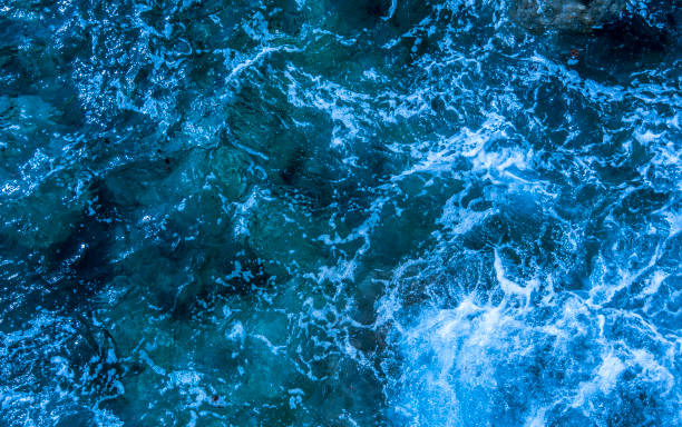 istock Blue deep sea foaming water background 1044184990