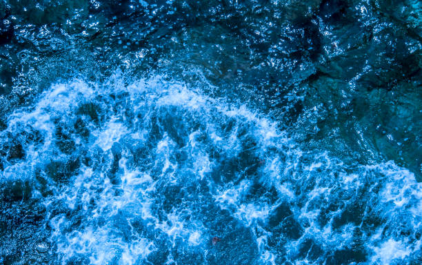 istock Blue deep sea foaming water background 1044185600