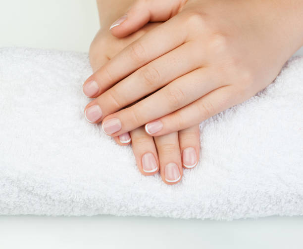 istock Beautiful female hands on white table. Manicure concept 1044185642