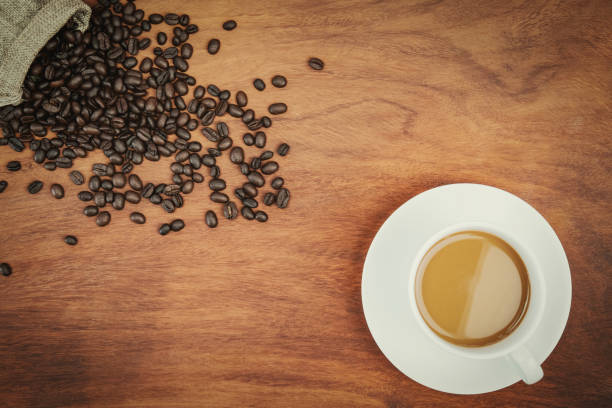 istock top view coffee cup and beans on wood background 1044185950