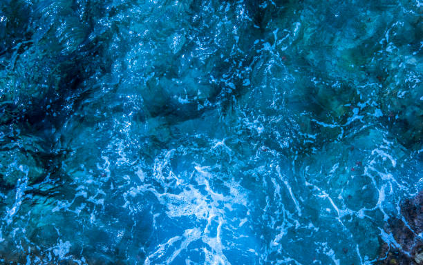 istock Blue deep sea foaming water background 1044188192