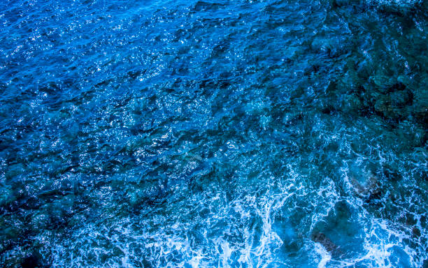 istock Blue deep sea foaming water background 1044188456