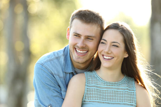 istock Happy couple looking away in a park 1044192890