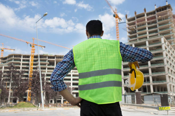 istock Young Engineer portrait with construction site and crane background. 1044192978