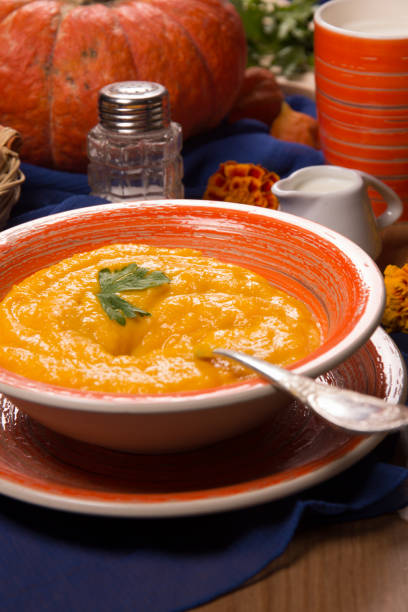 istock Pumpkin cream soup in a plate on the kitchen table 1044196022