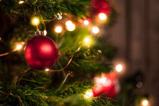 istock Red Christmas ball on a Christmas tree on a wooden wall background 1044200052