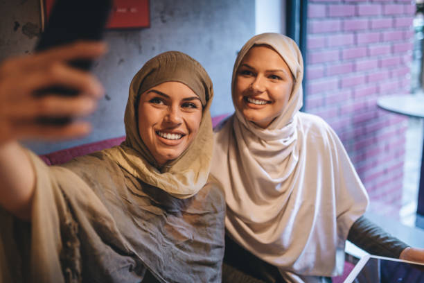 istock Cute Arabic university students enjoying their time doing selfies 1044201796