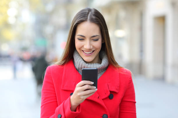 istock Woman reading a phone message in winter 1044202524
