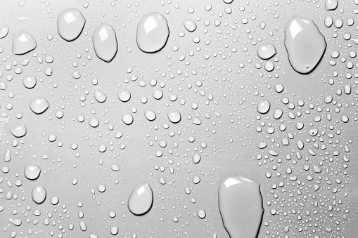 Clear water drops on gray background