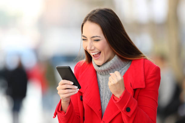 istock Excited woman using a smart phone in winter 1044204276