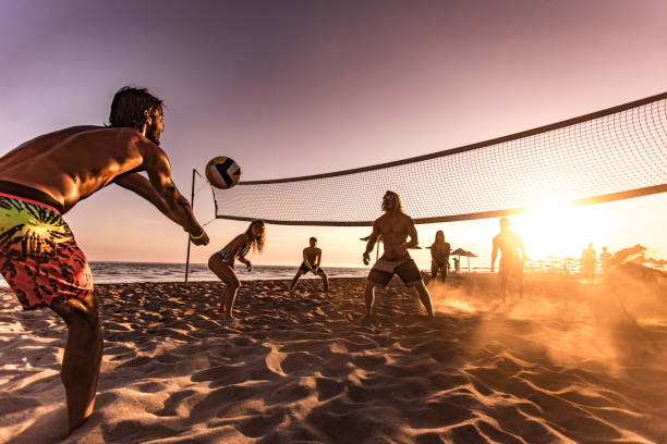 istock Young friends having fun while playing beach volleyball at sunset. 1044205746