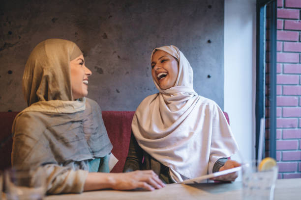 istock Islamic students having fun in a cafe having a drink 1044206100