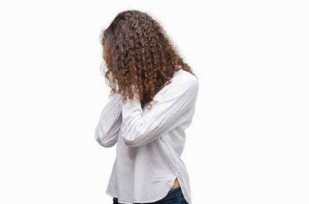 istock Beautiful young hispanic woman with sad expression covering face with hands while crying. Depression concept. 1044206964