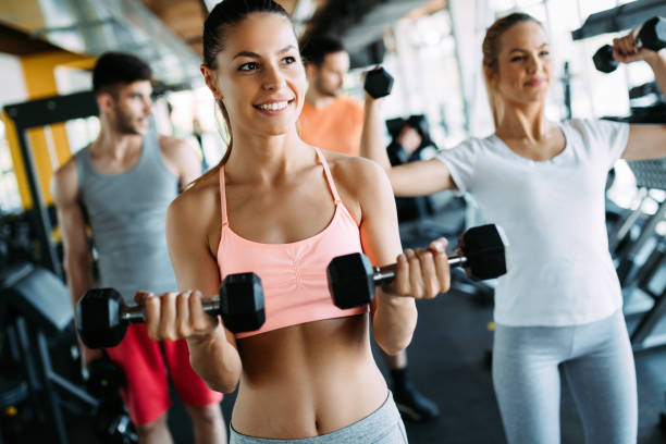 istock Young women doing exercises in gym together 1044207716