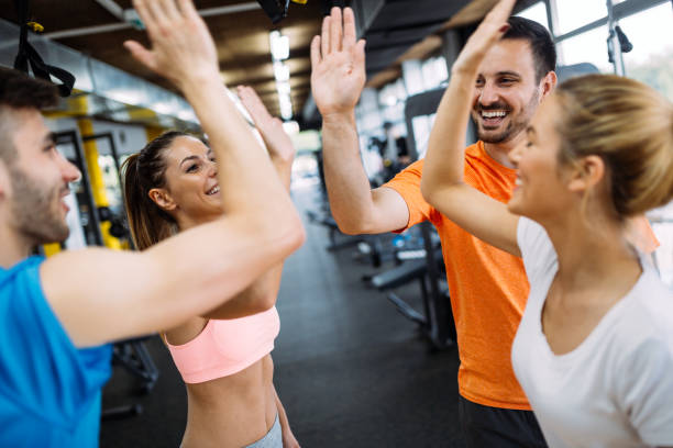 istock Happy fitness class giving high-five after completing exercise session 1044210500