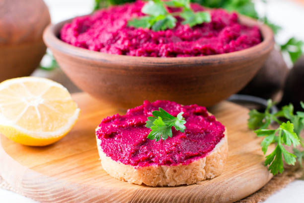 istock Roasted Beet Hummus with toast in a ceramic bowl 1044212752