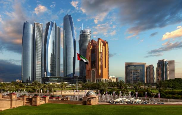 Skyscrapers in Abu Dhabi Abu Dhabi, United Arab Emirates, March 31, 2018: Abu Dhabi skyscrapers including Etihad Towers. In the middle with the flag of the United Arab Emirates. abu dhabi stock pictures, royalty-free photos & images