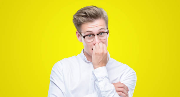istock Young handsome blond man looking stressed and nervous with hands on mouth biting nails. Anxiety problem. 1044215990
