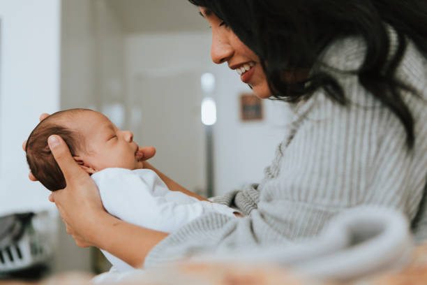 istock Mother holding her infant baby 1044216532