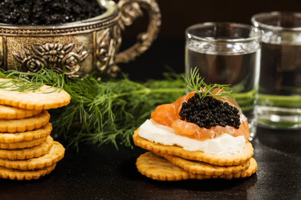 istock Black caviar served on crackers with vodka and additives 1044216668
