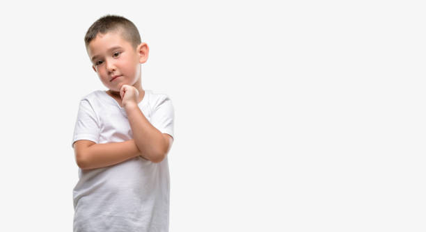 istock Dark haired little child serious face thinking about question, very confused idea 1044217906