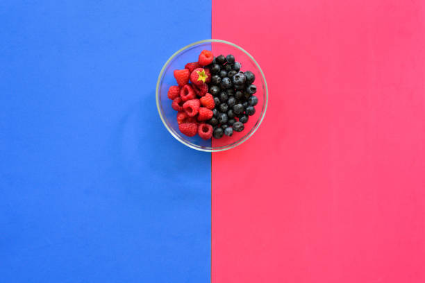 istock Blueberry and raspberry bowl on colorful background 1044218292