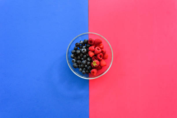 istock Blueberry and raspberry bowl on colorful background 1044222740