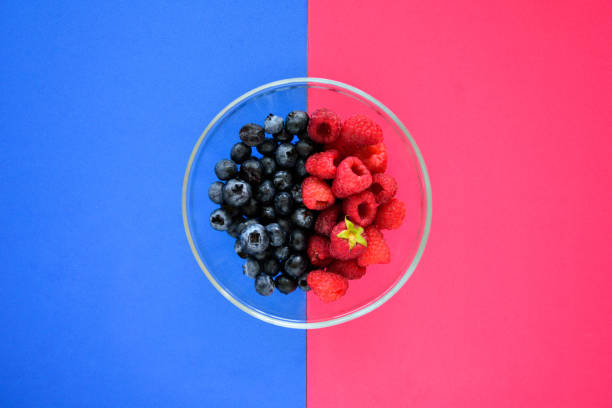istock Blueberry and raspberry bowl on colorful background 1044223186