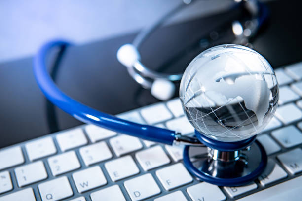 Global healthcare concept. World globe crystal glass on blue stethoscope on white keyboard. Health and medical science. Worldwide wellness business and technology Global healthcare concept. World globe crystal glass on blue stethoscope on white keyboard. Health and medical science. Worldwide wellness business and technology world health organization photos stock pictures, royalty-free photos & images