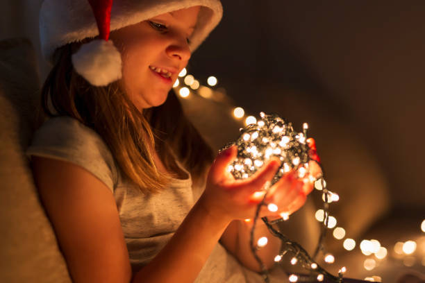 istock Little girl setting up Christmas lights 1044229072