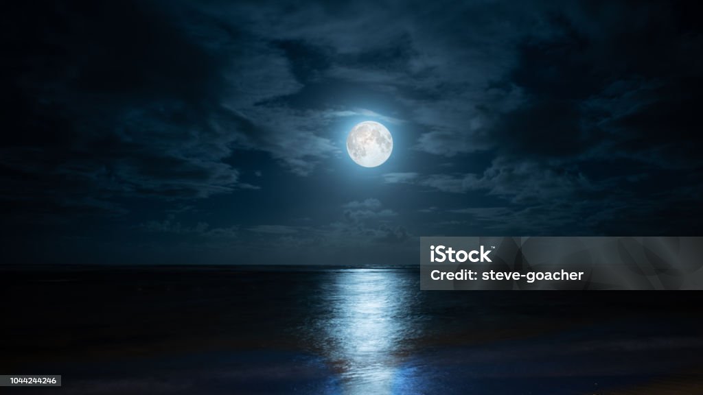 Blue moon over Poste Lafayette in Mauritius. Composite image of moonrise on the eastern coast of Mauritius at Poste Lafayette. Moon Stock Photo