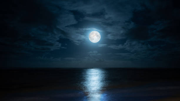 Blue moon over Poste Lafayette in Mauritius. Composite image of moonrise on the eastern coast of Mauritius at Poste Lafayette. moonlight stock pictures, royalty-free photos & images