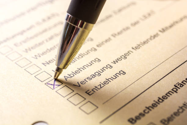 istock Yellow document in an office with the german words Rejection, failure and deprivation with the cross in rejection 1044247496