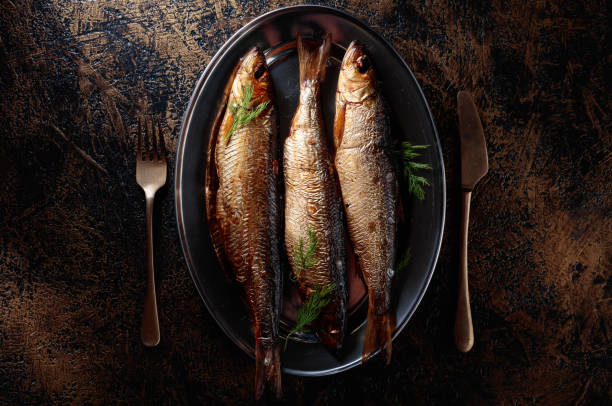 Smoked Baltic herring with dill. Smoked Baltic herring with dill. Copy space for your text. kipper stock pictures, royalty-free photos & images