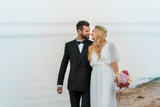 istock affectionate wedding couple going to kiss on beach 1044249264