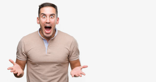 istock Handsome young man very happy and excited, winner expression celebrating victory screaming with big smile and raised hands 1044257176