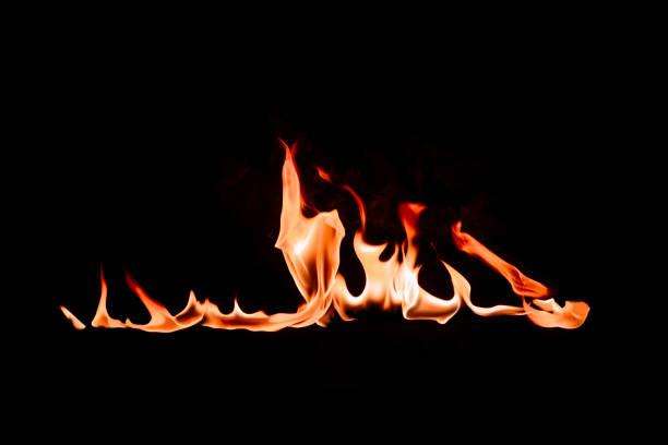 istock close up view of burning flame on black backdrop 1044259198