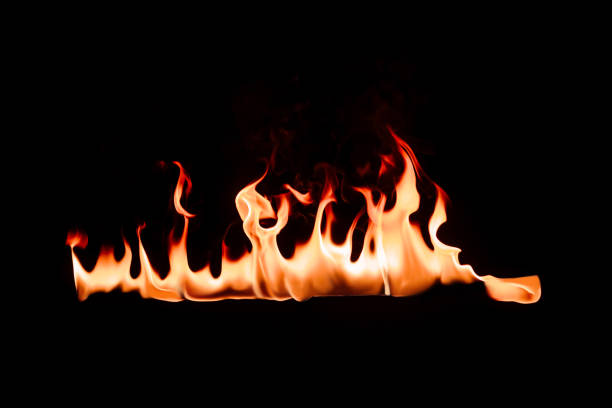 istock close up view of burning flame on black backdrop 1044259202