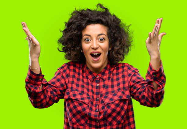 istock Beautiful arab woman happy and surprised cheering expressing wow gesture 1044266584