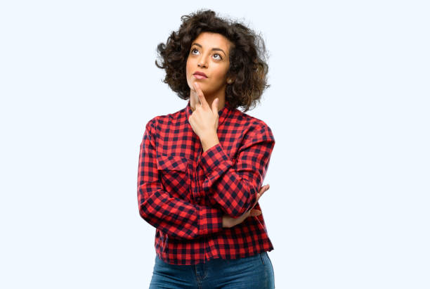 istock Beautiful arab woman thinking and looking up expressing doubt and wonder 1044266628