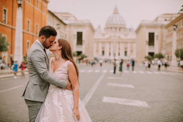 istock Young wedding couple by Saint Peter cathedral in Vatican 1044266698