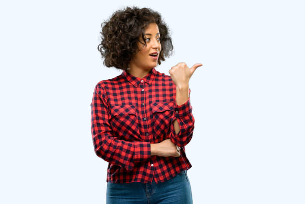 istock Beautiful arab woman pointing away side with finger 1044267160