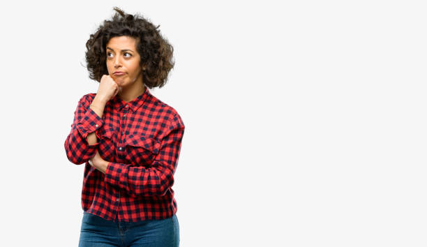 istock Beautiful arab woman thinking and looking up expressing doubt and wonder 1044267704